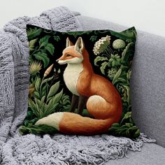 a pillow with a fox and flowers on it