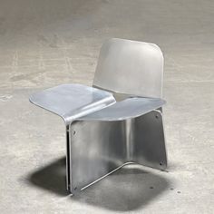 a metal chair sitting on top of a cement floor