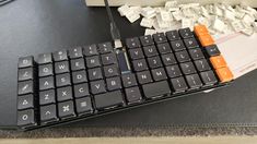 a computer keyboard sitting on top of a table