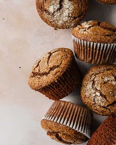 several muffins with powdered sugar on top