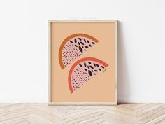 a watermelon print hanging on a wall next to a wooden parquet floor