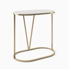 a white and gold table with curved legs