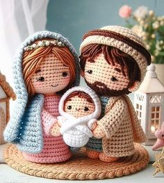 a crocheted figurine of two people holding a baby