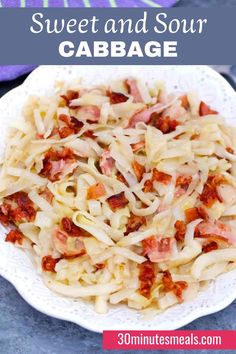 a white plate topped with pasta and bacon