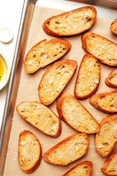 toasted pieces of bread sitting on top of a baking sheet