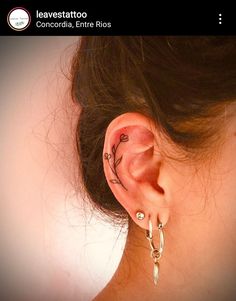 a woman's ear with a tattoo on it