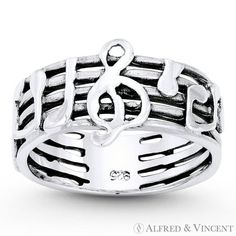 The featured ring is cast in oxidized .925 sterling silver and showcases a sheet-music design made up of a 5-line stave with a G-Clef centerpiece and musical notes on the sides. Your purchase will include a 30-Day Exchange or Money-Back Guarantee & Free US Shipping. Please email us for more details regarding this listing. Color: Metal Type.  Gender: unisex.  Age Group: adult. Bead Bar, Masonic Ring, Stackable Bands, Engagement Ring Shapes, Right Hand Rings, Musical Notes, Musical Note, Music Design, Charm Rings