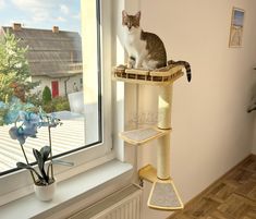 The new spring collection of furniture for cats from our company includes a unique product - a wall tree for cats with a shelf on top and two additional steps. This is the perfect solution for your beloved pets who love to lie on high places and jump from one place to another. 📢ATTENTION!! The location of this shelf is to RIGHT of window!! The set includes: 1. Adjustable shelf with a pillow - 1 pc. -length - 19.3" (48 cm) -width - 11.0" (28 cm) 2. Sisal scratching post - 2 section. -height - 28" (72 cm) 3. Step - 2 pcs.  -length - 11.8" (30 cm) -width - 8.6" (22 cm) ❓The same cat tree but with shelf positioned for LEFT side of the window at the link: https://www.etsy.com/listing/1431120200/cat-tree-furniture-cat-shelves-modern?click_key=c8d74467b8c0af2cd2b5b6835737a4e9fd9e8358%3A143112020 Shelves Above Windows, Wall Above Stairs Decor, Diy Cat Wall Ideas, Plant Shed, Cat Window Perch, Cat Shelf, Window Perch, Outdoor Cat Enclosure, Cat Wall Furniture