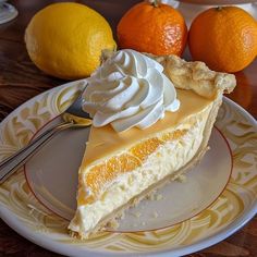 a piece of cheesecake on a plate next to oranges