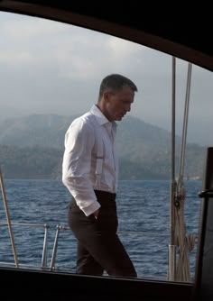 a man is walking on the deck of a boat