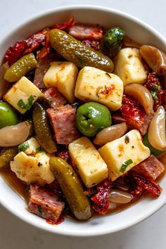 a white bowl filled with different types of food on top of a marble countertop