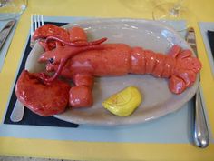 there is a plate with a lobster and lemon on it