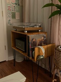 a record player sitting on top of a wooden shelf