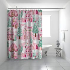 a bathroom with a pink shower curtain and white bathtub in front of a window