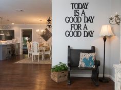 a living room filled with furniture and a wall mounted quote on the wall above it