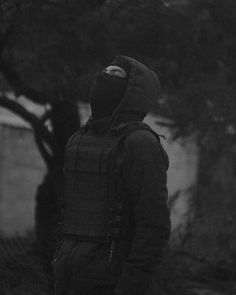 black and white photograph of man in hooded jacket