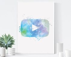 a watercolor painting with a play button on it next to a potted plant