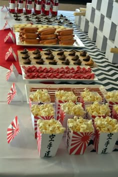 many different types of food are displayed on the table for people to eat at this event