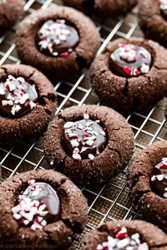 chocolate cookies with white and red sprinkles on a cooling rack