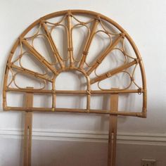 an arched bamboo headboard is shown against a white wall