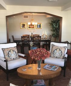 a living room with two chairs and a table