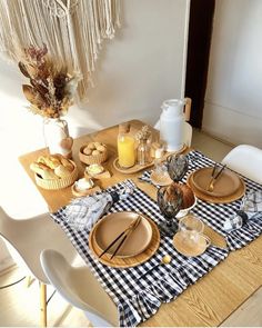 a table with plates, cups and utensils on it