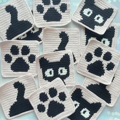 black and white crocheted coasters with cat's paw prints on them