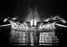 a person swimming in the water with their arms out and splashing on it's back