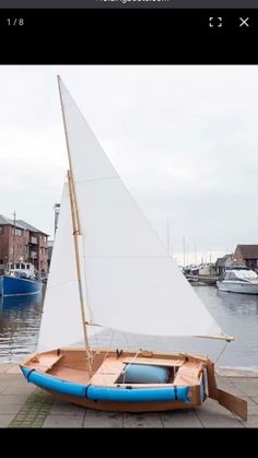 a small sailboat sitting on top of a sidewalk