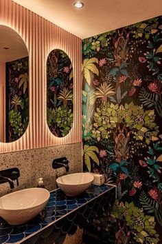 a bathroom with two sinks, mirrors and wallpaper