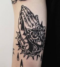 a black and white tattoo on the arm of a woman with a rose in her hand