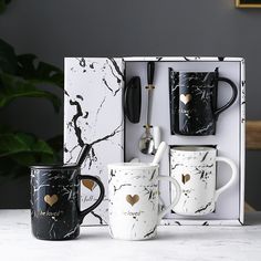 three coffee mugs in a gift box with gold hearts