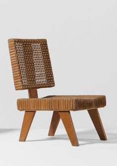 a wooden chair with wicker back and seat cushion on the bottom, in front of a white background