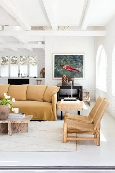 a living room filled with furniture and a painting on the wall