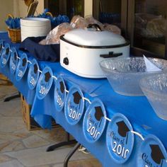 a blue table topped with lots of plates and bowls