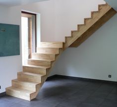 an empty room with a wooden stair case