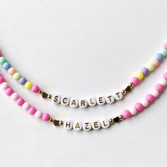 Add a burst of vibrant charm to your little one's outfit with our Bright Colorful Beads Name Necklace! This delightful piece combines the timeless elegance of dainty gold name beads with an array of eye-catching, colorful hued beads. Your child's name is spelled out in gold and adorned with a captivating spectrum of colors, creating a personalized gift that will surely bring smiles. This necklace would make a perfect birthday gift for little girls.  Perfect for Easter too! Colorful acrylic beads strung on wire and accented with Gold letter Beads, 18k plated heart beads and 18k plated gold ball beads. 18K gold hearts or 18K round ball beads.   Choose which style you would like from the drop down menu along with the length of the necklace. Necklace is packaged for gift giving. To see more Ki Cute Personalized Multicolor Charm Necklaces, Playful Beaded Charm Necklaces For Gifts, Playful Beaded Charm Necklace For Gifts, Playful Beaded Charm Necklaces As Gifts, Multicolor Beaded Jewelry For Birthday Gift, Playful Rainbow Jewelry With Letter Beads, Playful Pink Charm Necklaces For Friendship, Fun Pink Adjustable Charm Necklace, Playful Pink Charm Necklace For Friendship