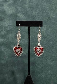 "Long Red Heart Evil Eye Halloween Witchy Earrings--Silvertone--Pagan Dangly Drop Earrings--Halloween Jewelry This is a long dangling earring.  These uniquely styled earrings have a filigree connector piece leading to a red enamel heart with a raised rose and an evil eye on the charm.  Halloween jewelry with Victorian style drop earrings for costumes, cosplay, LARP, Renaissance Faires, Witchy Coven meetings and Vampire Balls. Approximately 3 1/2\" inches long, yet with a slim, narrow profile. If Gothic Metal Earrings For Valentine's Day, Silver Gothic Earrings For Valentine's Day, Gothic Dangle Earrings For Valentine's Day, Gothic Dangle Heart Earrings For Gift, Gothic Heart-shaped Pierced Jewelry, Nickel-free Dangle Heart Earrings For Festivals, Silver Heart Plug Earrings Gift, Metal Jewelry With Ear Wire For Valentine's Day, Pierced Metal Jewelry For Valentine's Day