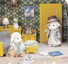 two stuffed animals are standing in front of a doll house with yellow furniture and green wallpaper