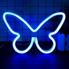 a butterfly shaped neon sign sitting on top of a table