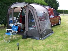 a car is parked next to a tent with the door open and it's windows closed