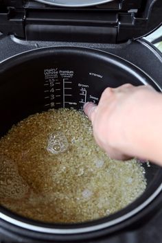 someone is adding rice into the slow cooker to make it easier for them to cook