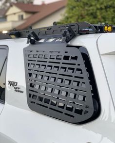 the back end of a white truck with a rack on it