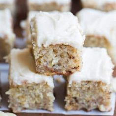 several pieces of cake sitting on top of a cutting board with bananas next to it