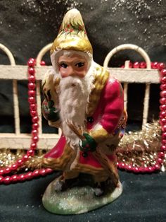 a santa clause figurine sitting on top of a table