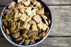 a bowl filled with croutons sitting on top of a wooden table