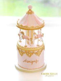 there is a pink and gold carousel cake