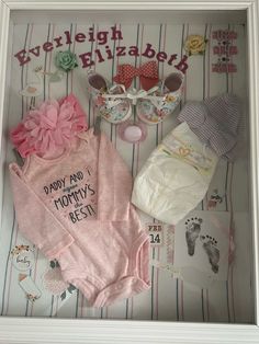 a baby's outfit and shoes are in a shadow box with the words, daddy and mommy's best