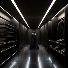 a man in a dark room with lots of closets and lights on the ceiling