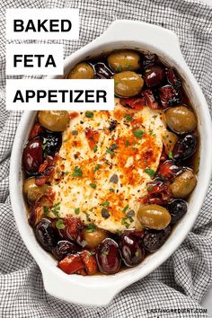 baked feta appetizer with olives and parmesan cheese in a white casserole dish